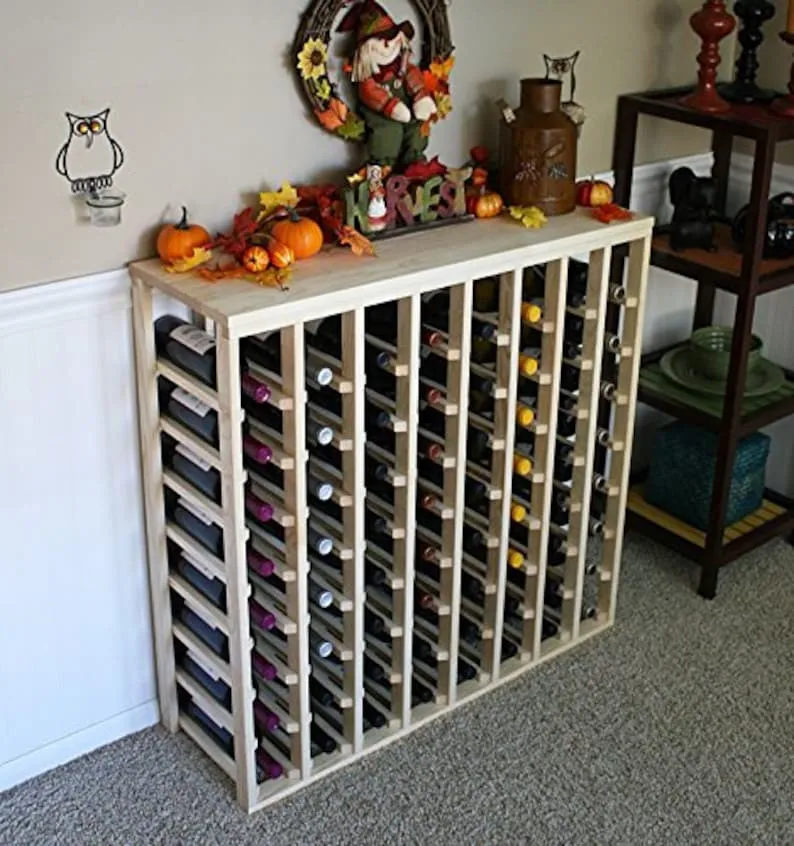 A wine rack with many bottles of wine on top.