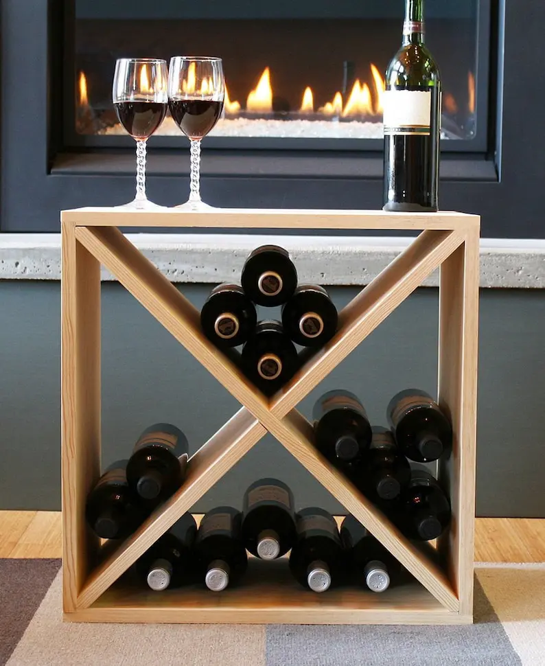 A wine rack with bottles of wine and two glasses.